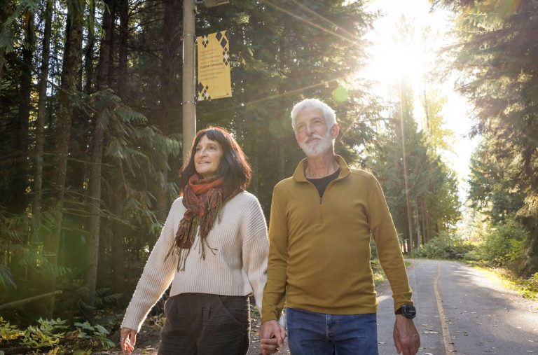 A senior couple walk along the Valley Trail in Whistler in the fall.