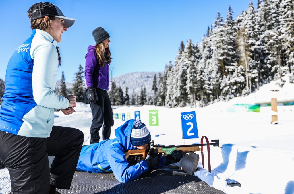 A person tries the biathlon experience at Whistler Olympic Park in the winter.