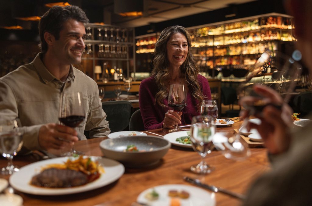 A group of people enjoy dinner at Wild Blue in Whistler.