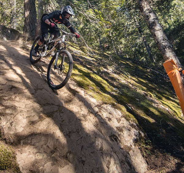 Downhill mountain biker in the Whistler Mountain Bike Park on a sunny day in Whistler, British Columbia, Canada