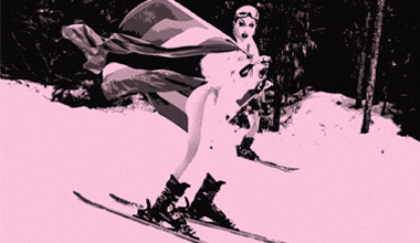 A Pride flag flies at the top of Whistler Mountain in the winter time.