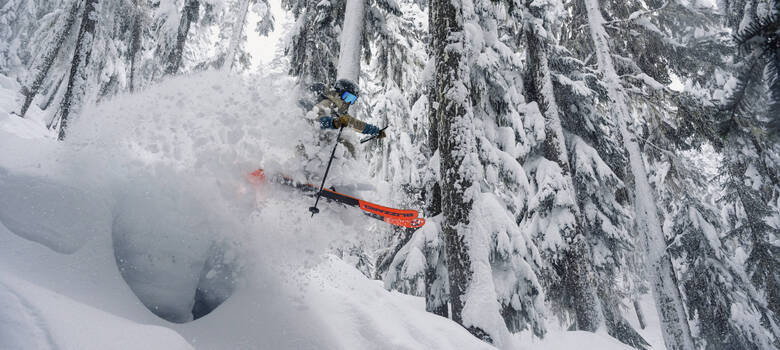 Skier blasting through powder in Franz's Meadows on Whistler Mountain