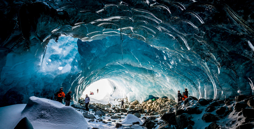 People Exploring an Ice Cave in Whistler