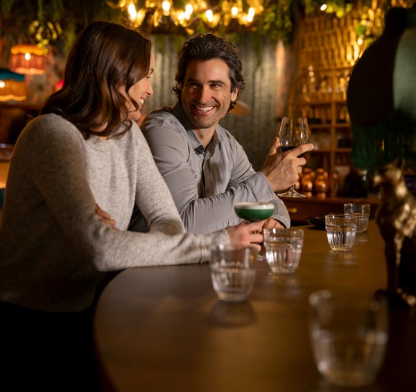 Couple enjoying craft cocktails at a stylish bar in Whistler, British Columbia, during an evening out in Whistler Village.