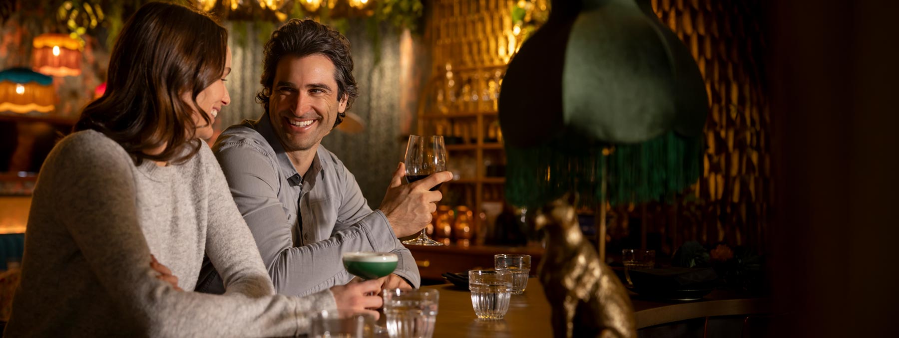 Couple enjoying craft cocktails at a stylish bar in Whistler, British Columbia, during an evening out in Whistler Village.
