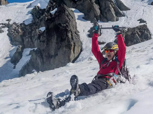 Guests glissading down summer snow on Whistler Mountain during a guided glacier tour.