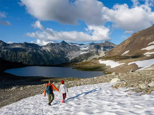Hikers approaching Iceberg Lake beneath Rainbow Mountain and Weart Glacier near Whistler.