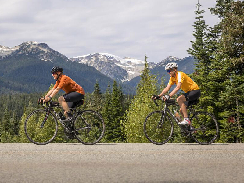 People road cycling on a sunny fall day in Whistler