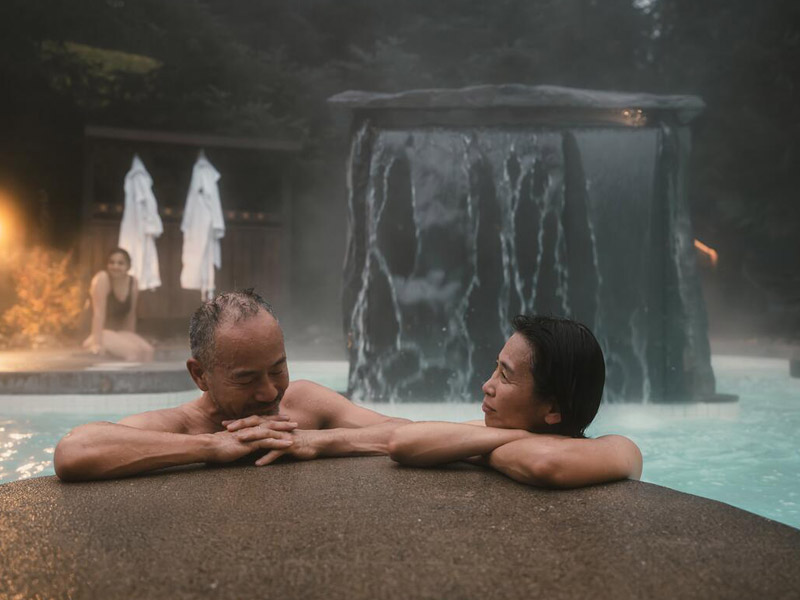 Two people enjoying a hot pool at a spa in Whistler
