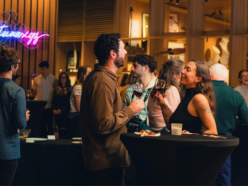 People chatting and enjoying themselves at an event at Audain Art Museum in Whistler