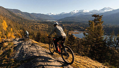 Two people fall trail riding on Enduro e-bikes on Beaver Pass trail in Whistler, British Columbia