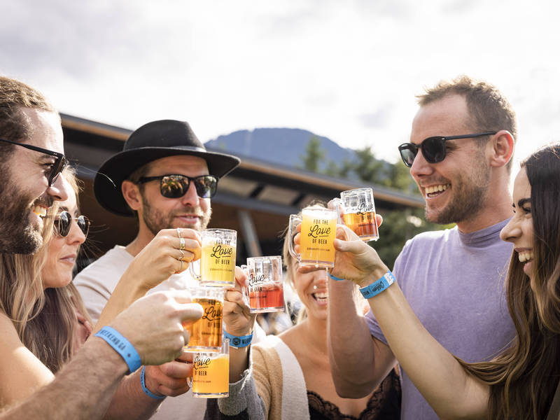 A group of people enjoying beer at Whistler Village Beer Festival in the fall