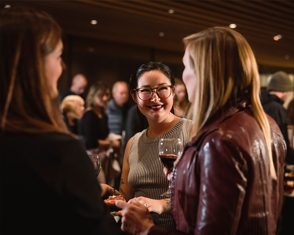 People drinking wine and enjoying art at Whistler Wine Walk in October