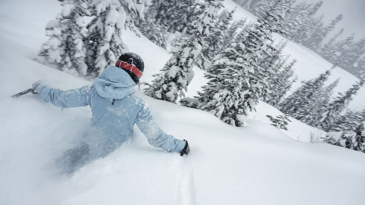 A skier waist deep in snow in Whistler