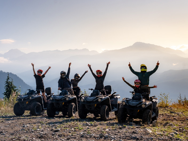 An ATV rider navigates a forest trail through Whistler's rugged backcountry on a guided Bushwhacker ATV Tour.