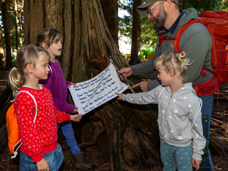 A family follows clues on a guided scavenger hunt through Whistler's forests, searching for hidden caches and historic treasures.