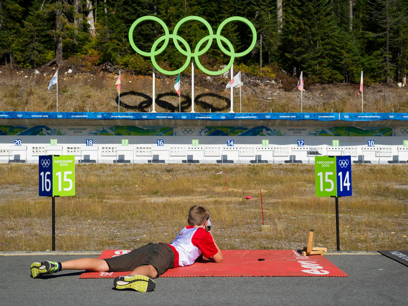A guest aims a .22 calibre biathlon rifle at the Olympic shooting range at Whistler Olympic Park.