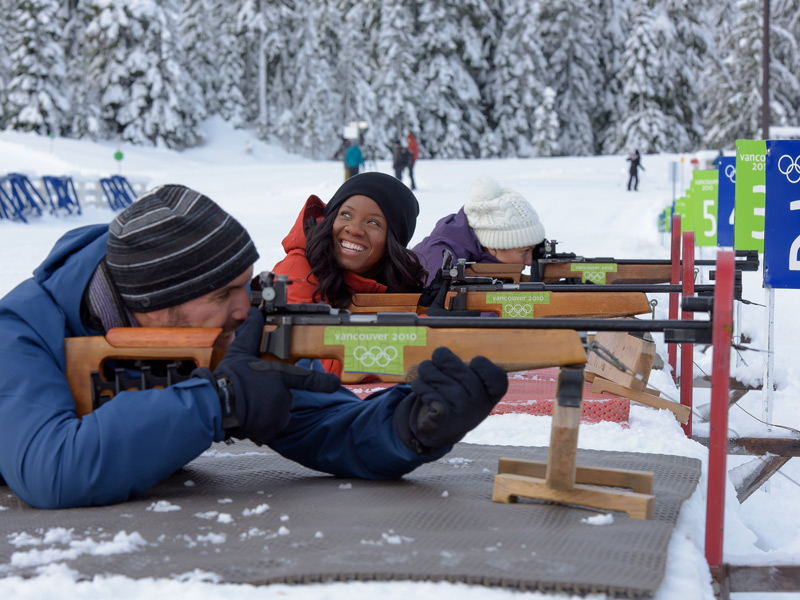 A guest learning biathlon at Whistler Olympic Park aims a .22 calibre rifle at the Olympic biathlon range.