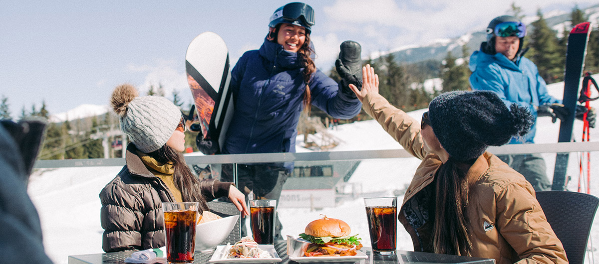 Friends enjoying apres food and drink in Whistler