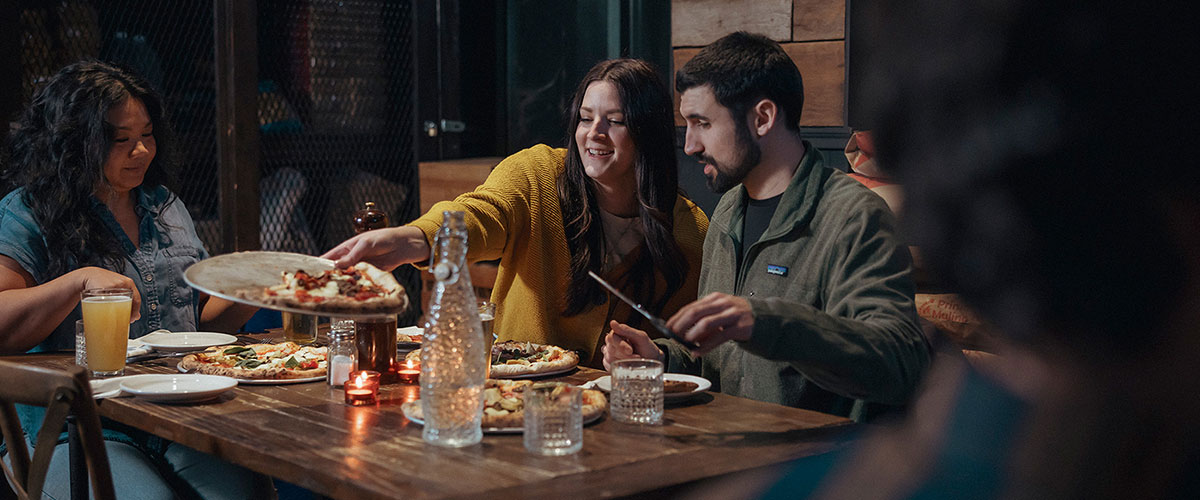 Group eating pizza at a restaurant