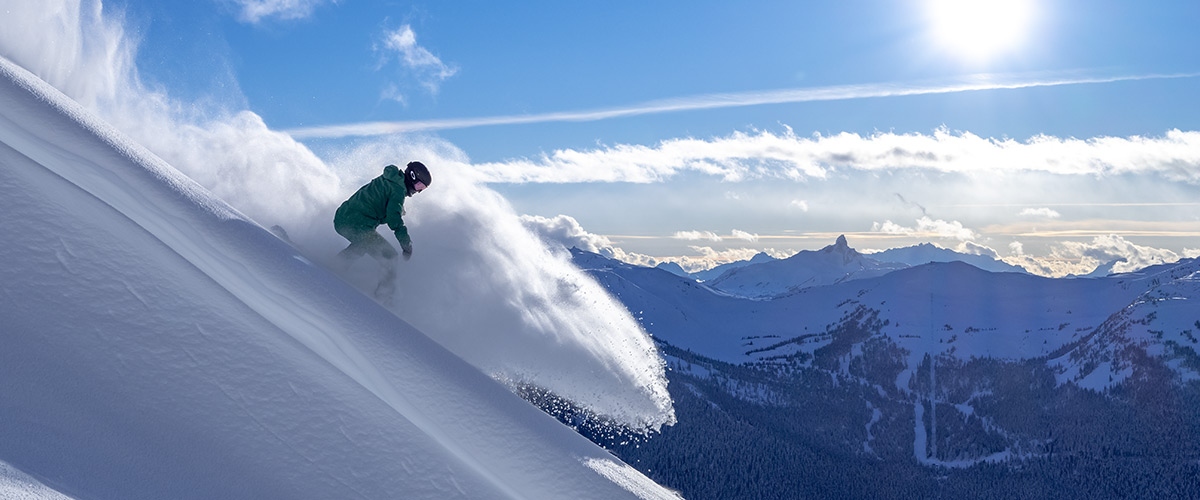 Snowboarder getting fresh tracks on Whistler