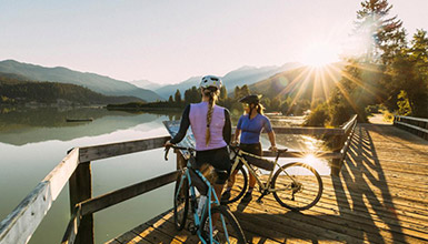 Two gravel riders taking in the views over Green Lake in Whistler, British Columbia.