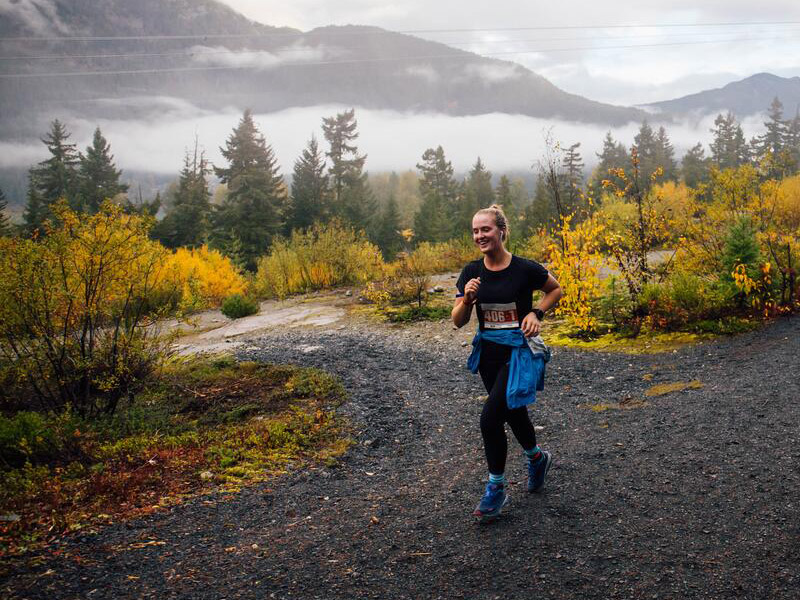 A person running near Lost Lake in Whistler in the fall