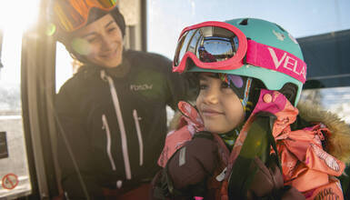 A mother and her child in a gondola cabin in Whistler Canada