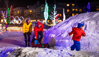 A family walking in Whistler Village during the holidays