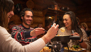 A group having a delicious fondue dinner in Whistler BC Canada