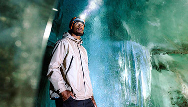 A person with a headlamp exploring an ice cave in Whistler, British Columbia