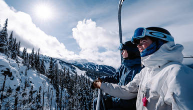 Two skiers on Crystal Chair on Blackcomb Mountain in Whistler, British Columbia