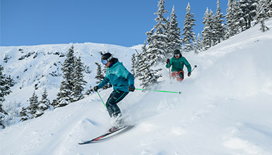 Skier with an instructor at Whistler Blackcomb in British Columbia Canada
