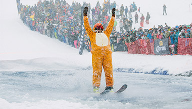 Skier dressed in a tiger onesie at the Slush Cup at Whistler's World Ski and Snowboard Festival