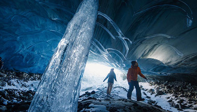 A couple exploring an ice cave in Whistler British Columbia