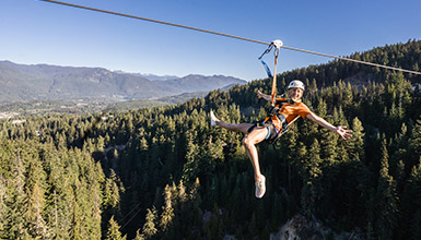 Person ziplining over the forest