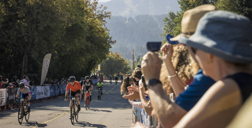 Cyclists biking in the Village during RBC GranFondo Whistler