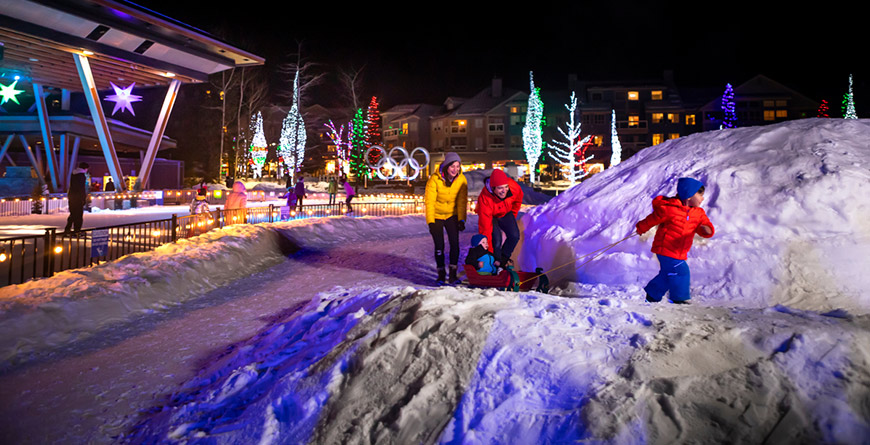 Family walking in Whistler Village during the holidays