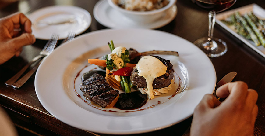A mouthwatering dinner plate on a well-laid table at a fine dining restaurant in Whistler, British Columbia